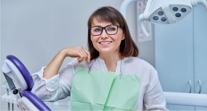 Patient smiling confidently after successful dental implants